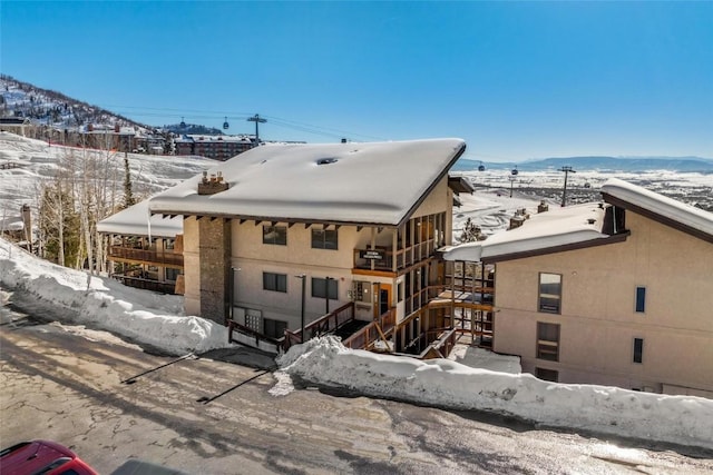 snow covered property featuring a mountain view
