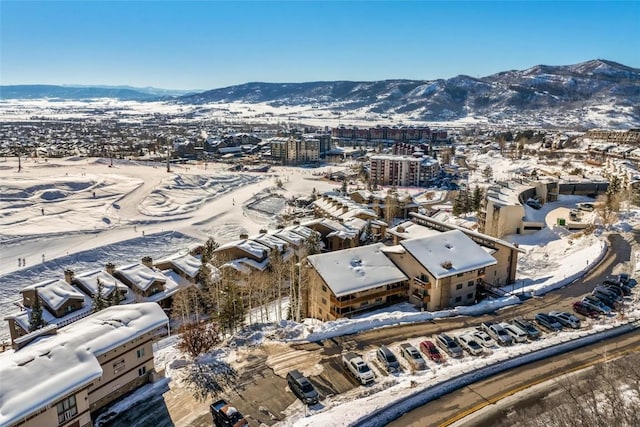 snowy aerial view with a mountain view