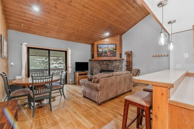 2915 Chinook Ln Unit B22, Steamboat Springs, CO 80487 - living room with vaulted ceiling, light wood-style floors, wooden ceiling, and a fireplace