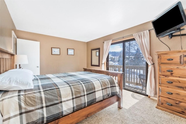 carpeted bedroom featuring access to exterior