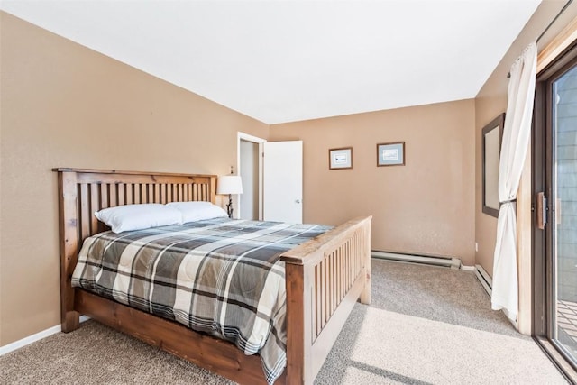 carpeted bedroom featuring a baseboard heating unit and baseboards