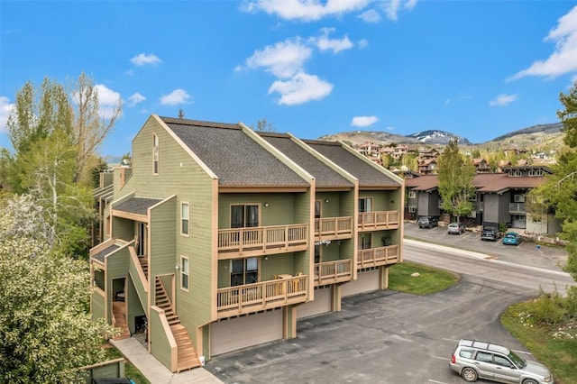 2915 Chinook Ln Unit B22, Steamboat Springs, CO 80487 - rear view of property with roof with shingles, a residential view, and a mountain view