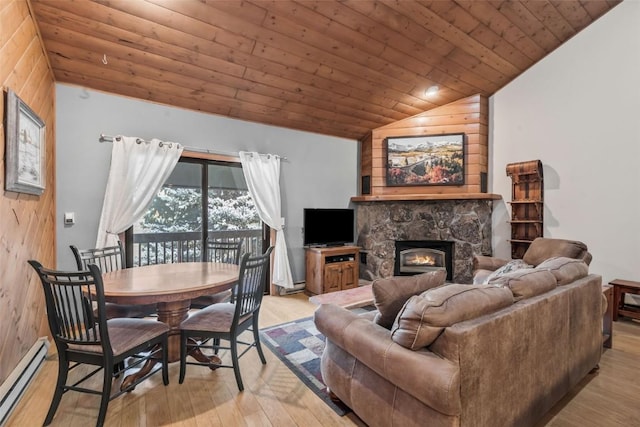 living area featuring lofted ceiling, light wood finished floors, wood ceiling, a fireplace, and baseboard heating