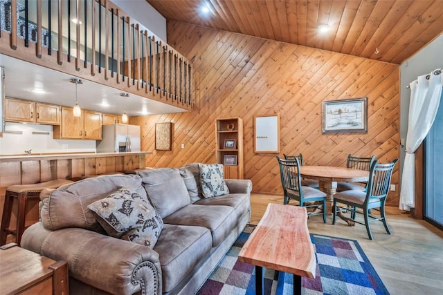 living room featuring wood walls, light wood-style flooring, wooden ceiling, and recessed lighting