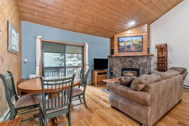 2915 Chinook Ln Unit B22, Steamboat Springs, CO 80487 - living area featuring vaulted ceiling, wood ceiling, light wood-style flooring, a baseboard radiator, and a fireplace