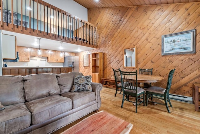 2915 Chinook Ln Unit B22, Steamboat Springs, CO 80487 - living room with light wood-style floors, a high ceiling, wood walls, and recessed lighting