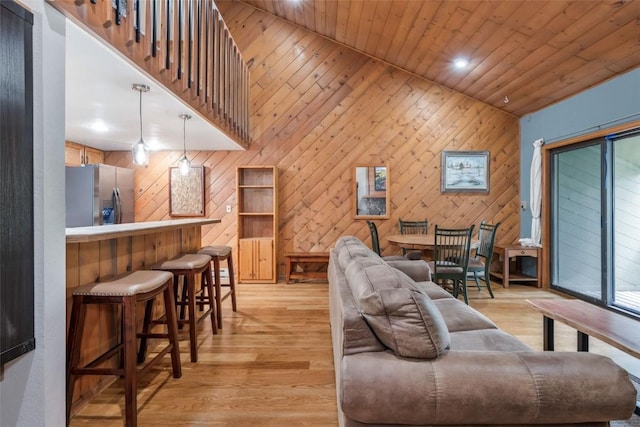 2915 Chinook Ln Unit B22, Steamboat Springs, CO 80487 - living room with wooden ceiling, wood walls, light wood-style floors, a high ceiling, and recessed lighting