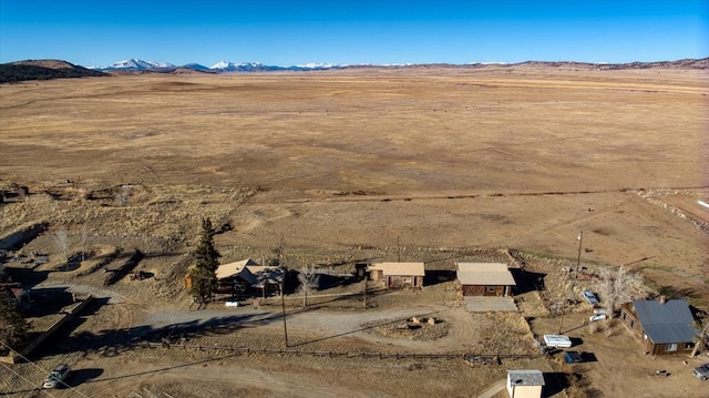 bird's eye view featuring a mountain view, a desert view, and a rural view