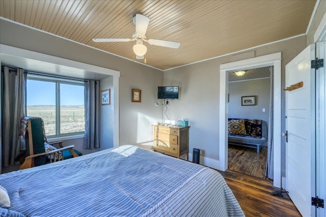 bedroom featuring ceiling fan, baseboards, and dark wood-type flooring