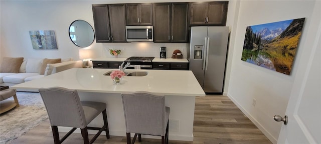 9279 Merino Ct # B, Littleton, CO 80125 - kitchen with stainless steel appliances, wood finished floors, light countertops, and decorative backsplash