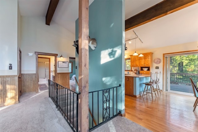 216 N Gold Flake Ter, Breckenridge, CO 80424 - hallway with beam ceiling, a wainscoted wall, rail lighting, light wood-style flooring, and an upstairs landing