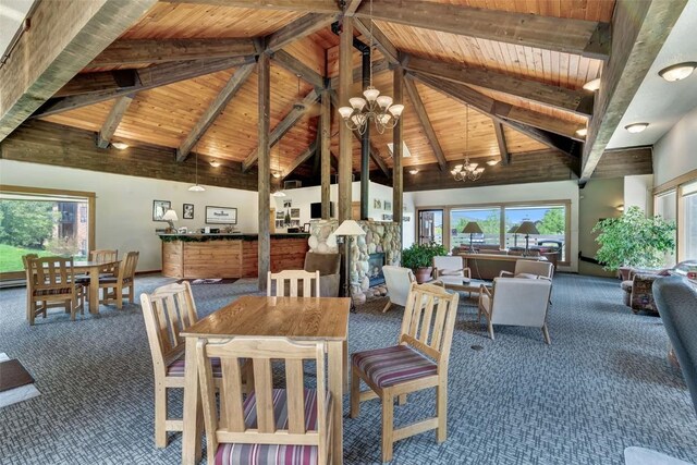 2350 Ski Trail Ln Unit 136, Steamboat Springs, CO 80487 - carpeted dining room featuring a chandelier, high vaulted ceiling, and wood ceiling with exposed beams