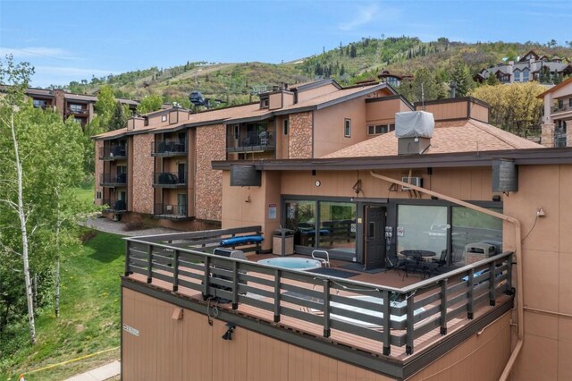 2350 Ski Trail Ln Unit 136, Steamboat Springs, CO 80487 - rear view of house with a mountain view, a chimney, and a shingled roof