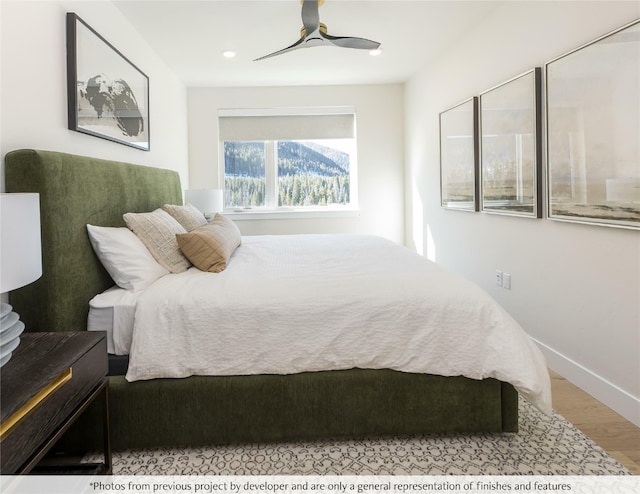 bedroom featuring baseboards, wood finished floors, and ceiling fan