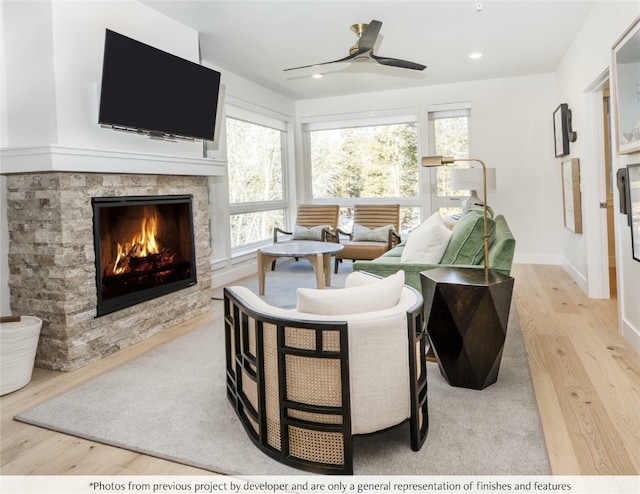 living area featuring wood finished floors, a fireplace, recessed lighting, and ceiling fan