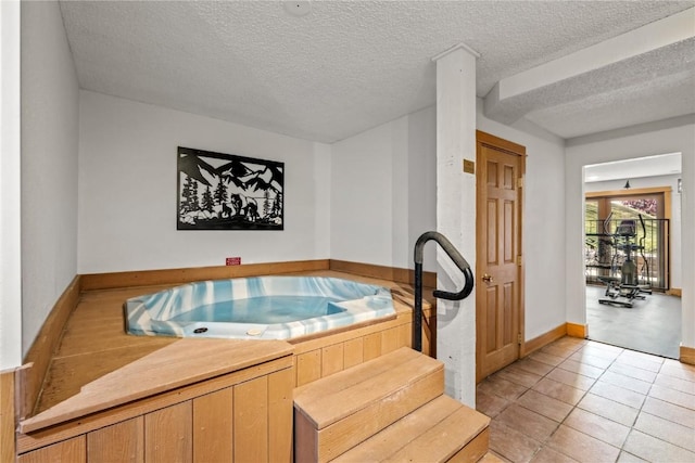 2350 Ski Trail Ln Unit 112, Steamboat Springs, CO 80487 - miscellaneous room featuring a textured ceiling, light tile patterned flooring, and a hot tub