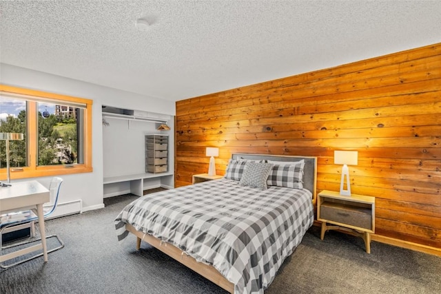 2350 Ski Trail Ln Unit 112, Steamboat Springs, CO 80487 - bedroom with carpet flooring, wooden walls, and a textured ceiling