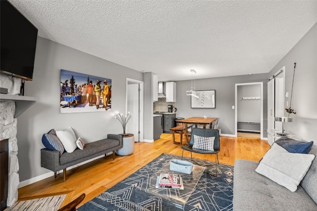 2350 Ski Trail Ln Unit 112, Steamboat Springs, CO 80487 - living room with light wood-style flooring, a fireplace, and a textured ceiling