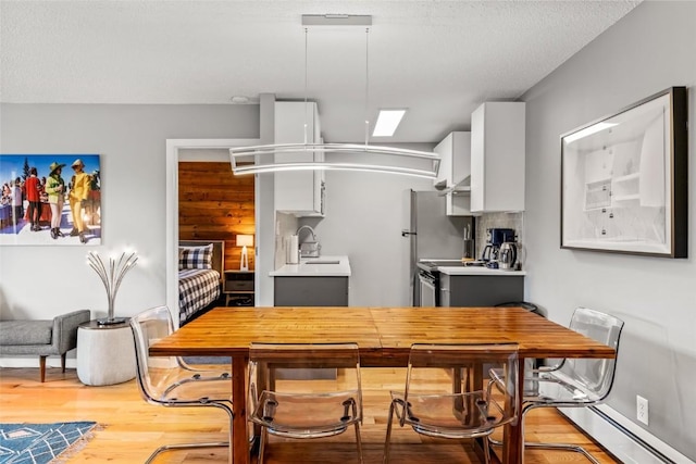 2350 Ski Trail Ln Unit 112, Steamboat Springs, CO 80487 - kitchen featuring light countertops, light wood-style floors, a baseboard heating unit, and stove