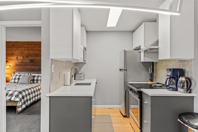 2350 Ski Trail Ln Unit 112, Steamboat Springs, CO 80487 - kitchen featuring electric range, extractor fan, decorative backsplash, light countertops, and light wood finished floors