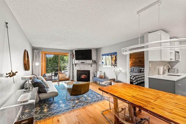 2350 Ski Trail Ln Unit 112, Steamboat Springs, CO 80487 - living area with a textured ceiling, hardwood / wood-style flooring, and a large fireplace