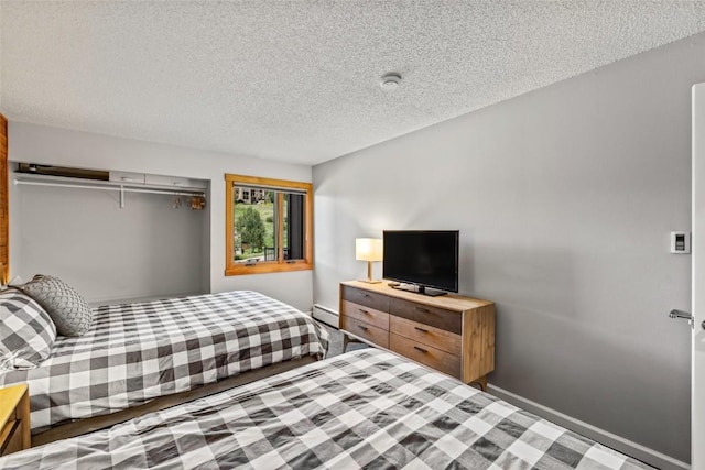 2350 Ski Trail Ln Unit 112, Steamboat Springs, CO 80487 - bedroom with a baseboard radiator and a textured ceiling