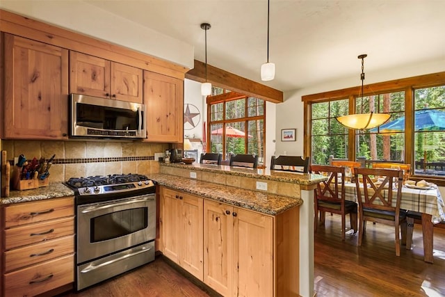 366 Moonstone Rd, Breckenridge, CO 80424 - kitchen with stainless steel appliances, a peninsula, healthy amount of natural light, dark wood finished floors, and beam ceiling
