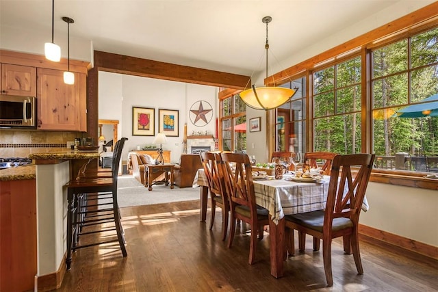 366 Moonstone Rd, Breckenridge, CO 80424 - dining room with dark wood-style floors, a fireplace, and beam ceiling