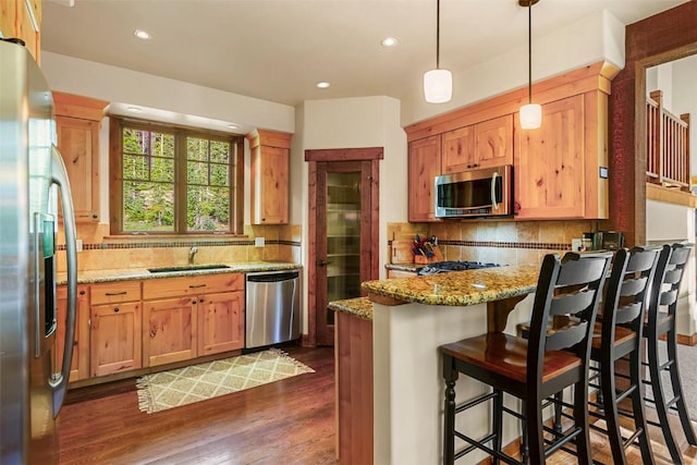 366 Moonstone Rd, Breckenridge, CO 80424 - kitchen featuring stainless steel appliances, a peninsula, decorative backsplash, light stone countertops, and recessed lighting