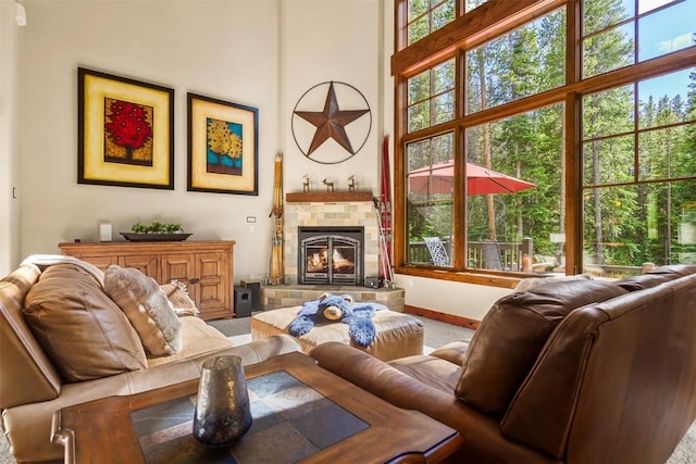 366 Moonstone Rd, Breckenridge, CO 80424 - carpeted living area featuring a tile fireplace, healthy amount of natural light, and a towering ceiling