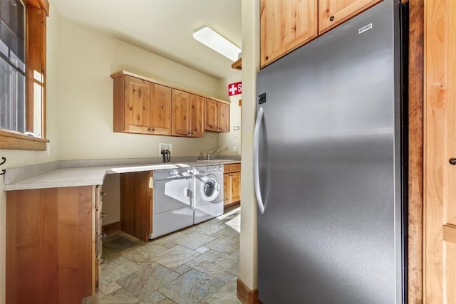 366 Moonstone Rd, Breckenridge, CO 80424 - laundry area featuring cabinet space, stone tile floors, and washing machine and dryer