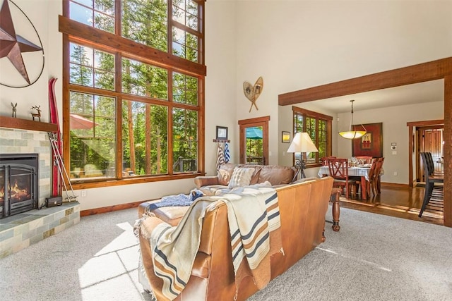366 Moonstone Rd, Breckenridge, CO 80424 - living area with carpet floors, a towering ceiling, and a fireplace