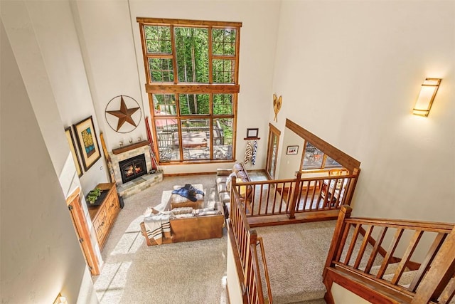 366 Moonstone Rd, Breckenridge, CO 80424 - carpeted living area featuring a glass covered fireplace, a towering ceiling, and stairs