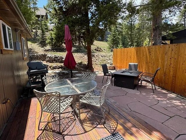 24 Magnum Bonum Dr, Breckenridge, CO 80424 - view of patio with a fire pit, grilling area, outdoor dining space, and fence