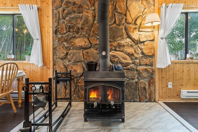 465 Mount Guyot Cir, Jefferson, CO 80456 - interior details with a wood stove, a baseboard heating unit, and wooden walls