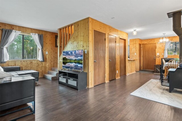 465 Mount Guyot Cir, Jefferson, CO 80456 - living area featuring an inviting chandelier, wood finished floors, wooden walls, and stairway