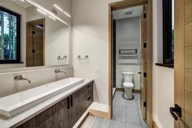 bathroom with tile patterned floors, vanity, and toilet