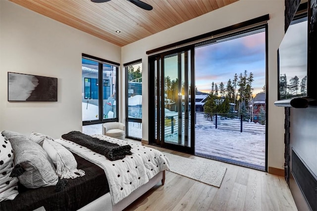 bedroom featuring access to exterior, light hardwood / wood-style floors, ceiling fan, and wood ceiling