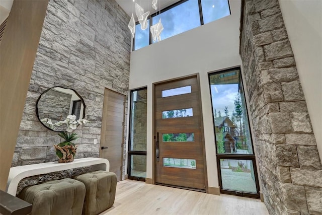 entryway featuring light hardwood / wood-style floors and a high ceiling