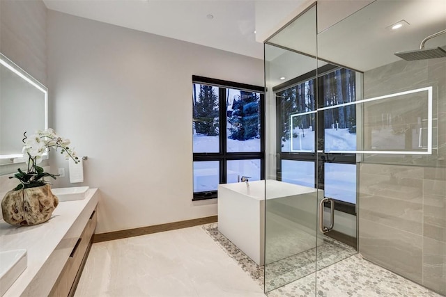 bathroom featuring vanity and shower with separate bathtub