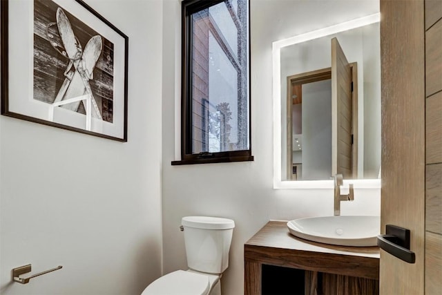 bathroom with vanity, toilet, and plenty of natural light