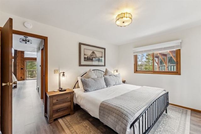 1009 American Way, Breckenridge, CO 80424 - bedroom with multiple windows, wood finished floors, and baseboards
