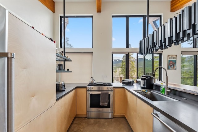 1009 American Way, Breckenridge, CO 80424 - kitchen featuring stainless steel appliances, a sink, finished concrete flooring, open shelves, and dark countertops