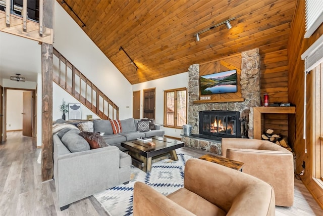 1009 American Way, Breckenridge, CO 80424 - living room featuring high vaulted ceiling, a fireplace, wood finished floors, track lighting, and stairway