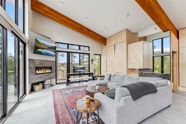 1009 American Way, Breckenridge, CO 80424 - living area featuring beam ceiling, concrete floors, a tiled fireplace, and high vaulted ceiling