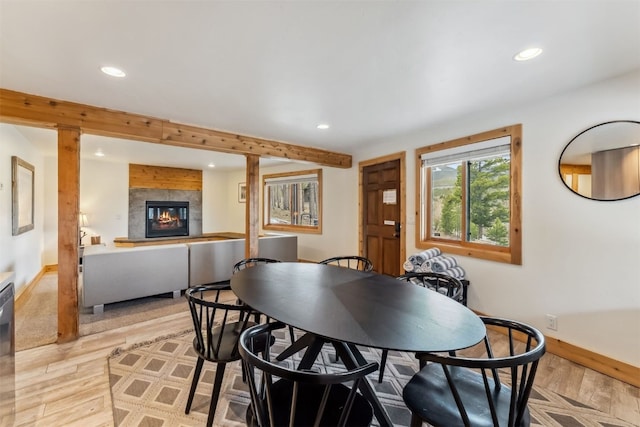 1009 American Way, Breckenridge, CO 80424 - dining room with recessed lighting, light wood-style floors, a glass covered fireplace, baseboards, and beam ceiling