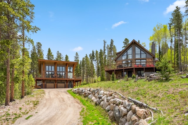 1009 American Way, Breckenridge, CO 80424 - chalet / cabin with driveway, a deck, a chimney, and an attached garage