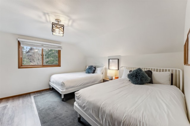 1009 American Way, Breckenridge, CO 80424 - bedroom with lofted ceiling, wood finished floors, and baseboards