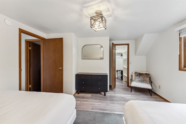 1009 American Way, Breckenridge, CO 80424 - bedroom with light wood-style floors, a walk in closet, and baseboards
