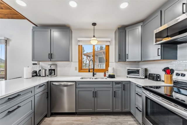 1009 American Way, Breckenridge, CO 80424 - kitchen featuring appliances with stainless steel finishes, a sink, gray cabinetry, recessed lighting, and light countertops